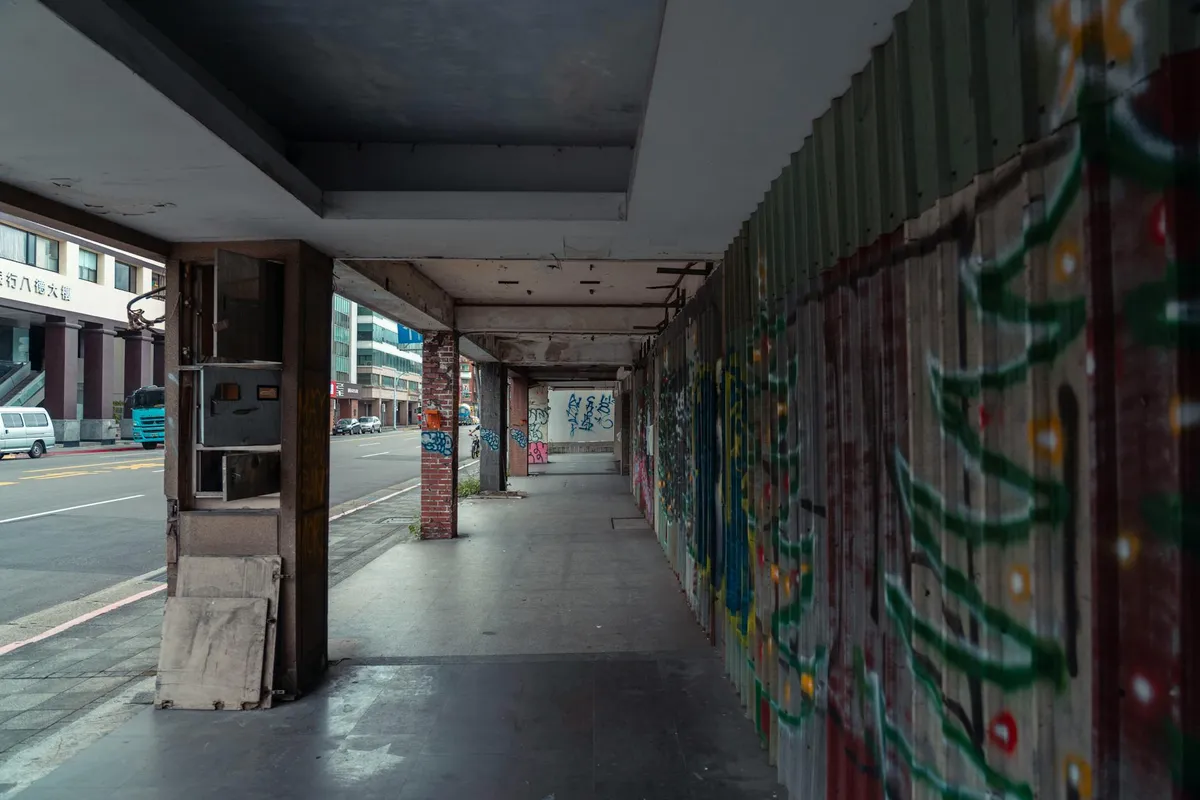 An urban wall with layers of street art and ownership signs